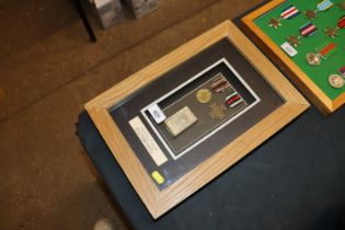 A frame of German WWI medals and match box cover