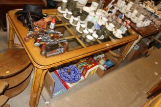 A glass topped and cane dining table