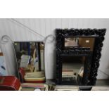 Two decorative black framed wall mirrors and a met