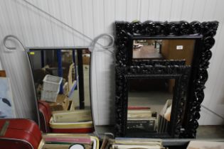 Two decorative black framed wall mirrors and a met