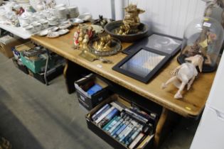 An oak refectory table raised on stretcher base