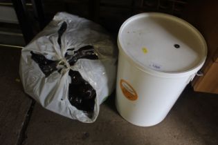 A plastic beer fermentation bucket and a quantity