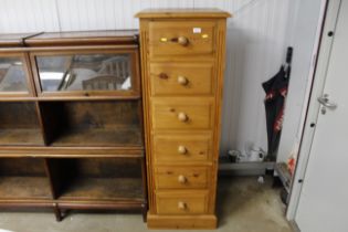 A modern pine tall chest fitted six drawers