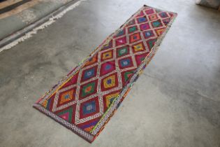 An approx. 10'3" x 2'7" Old Suzni runner