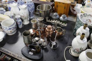 A collection of metal ware including Champagne bucket, cocktail shaker, candle stands etc