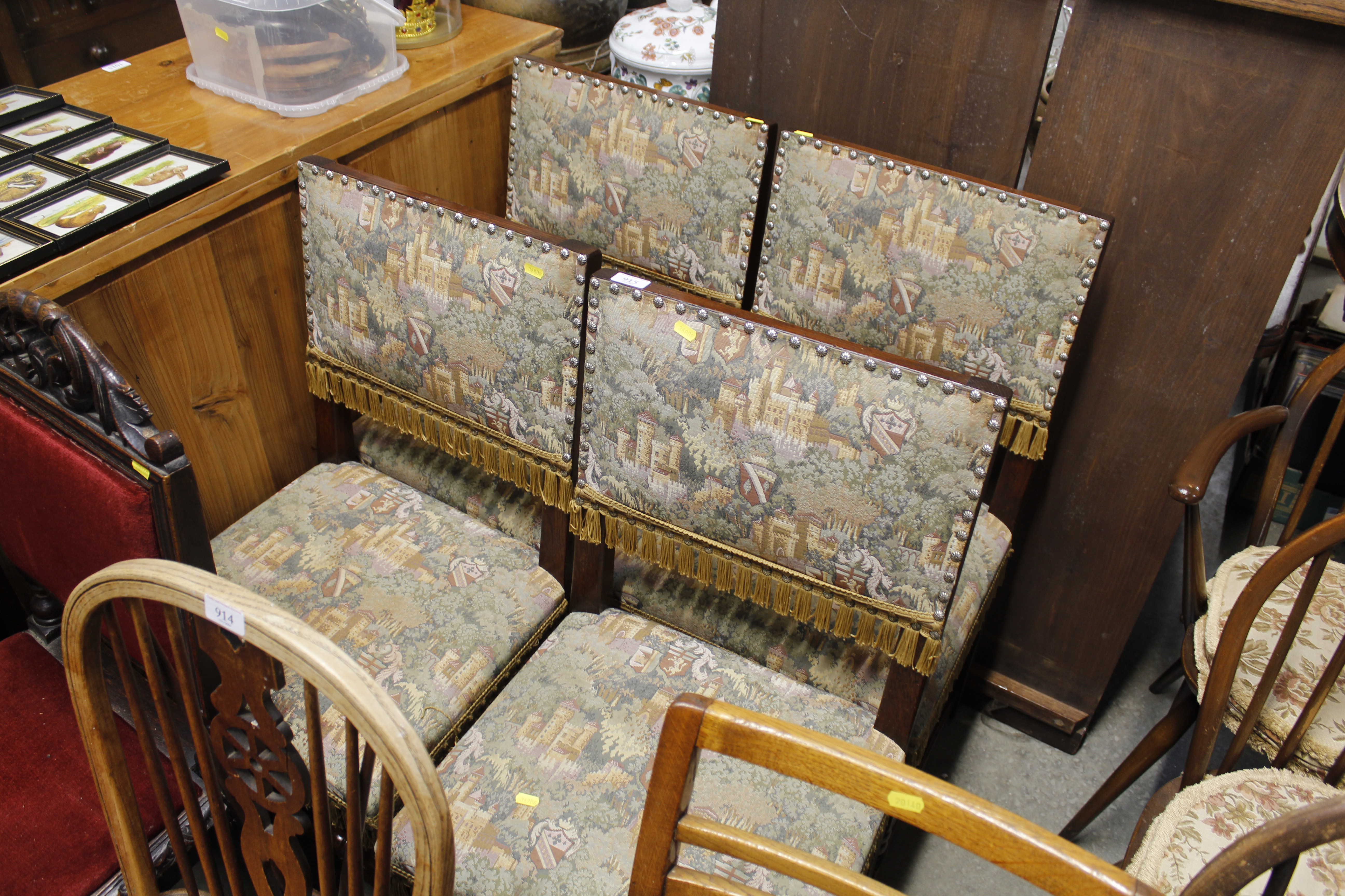 A set of four oak framed Jacobean style dining chairs with tapestry style upholstery