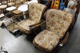 A pair of Ercol stick back armchairs