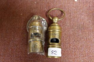 Two reproduction brass whistles