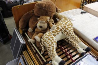 A collection of soft toys including bear and giraf