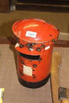 A recycled tin model in the form of a post box/bir