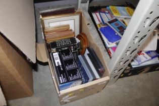 A box of miscellaneous DVDs, prints etc