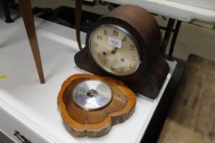 An oak cased two hole mantle clock and a barometer