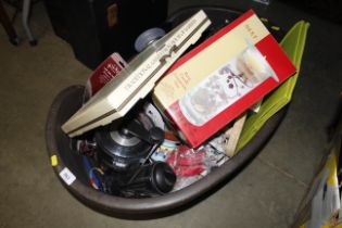 A dog basket with contents of miscellaneous kitche