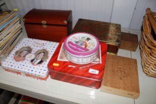 A collection of wooden boxes and advertising tins
