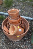 A quantity of various terracotta plant pots