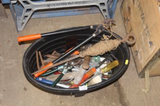 An oval plastic tub containing various tools to in