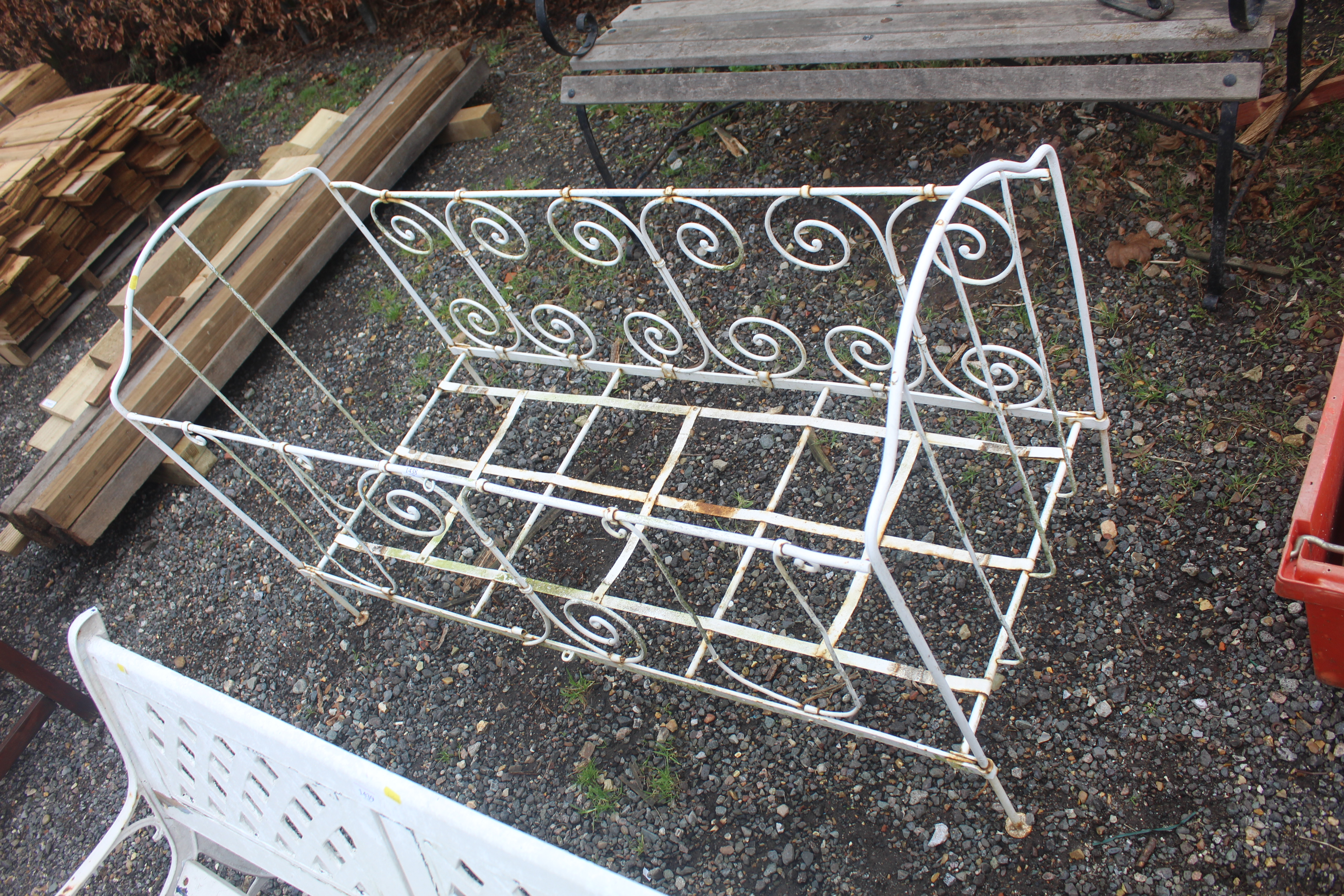 A white wrought metal child's daybed