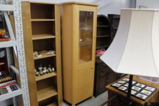 A modern light wood display cabinet with cupboard