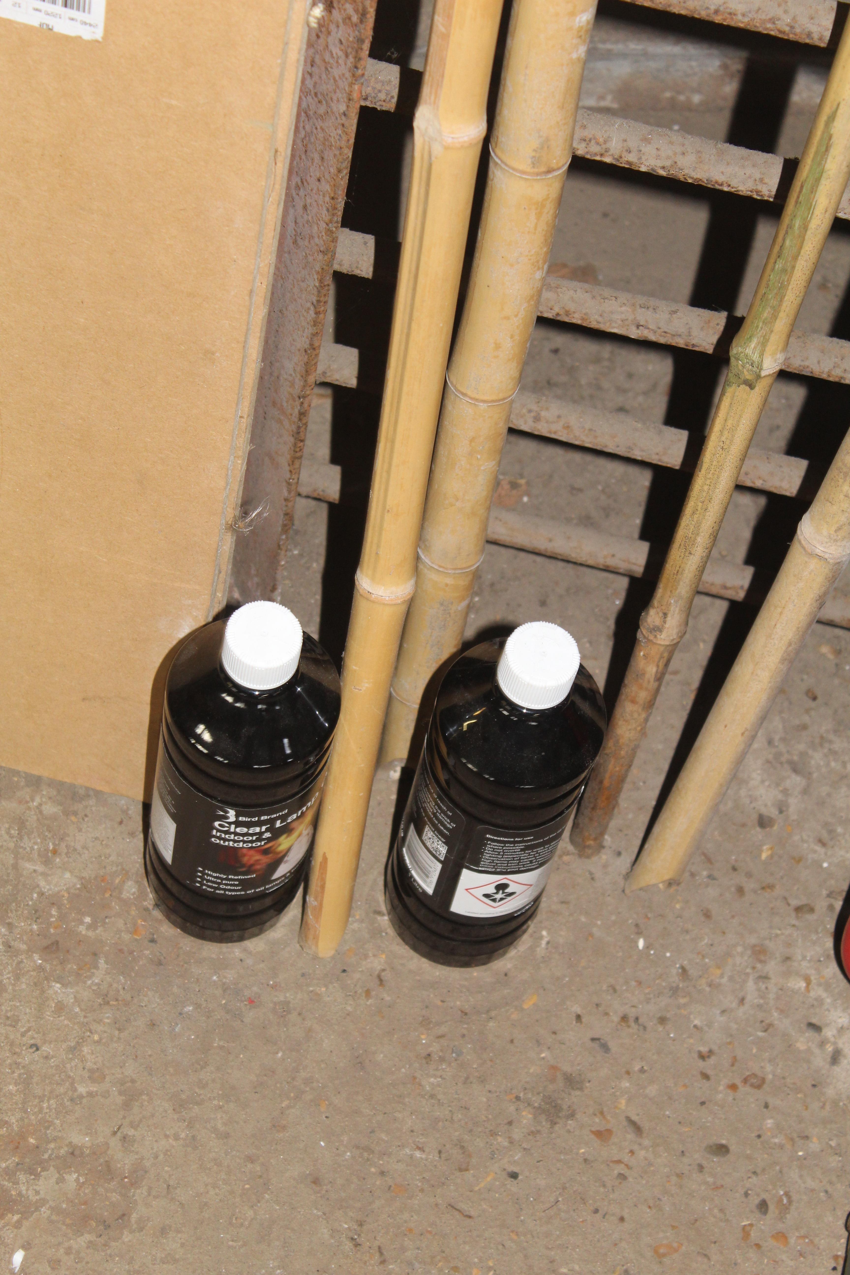 Four garden bamboo oil lanterns; and two bottles o - Image 2 of 2