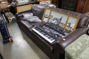 A brown leather upholstered three seat settee