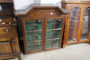 An antique walnut display cabinet