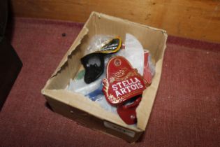 A box of various advertising bottle openers