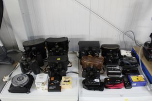 A quantity of various binoculars, cameras with var