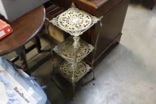 An ornate brass three tier stand