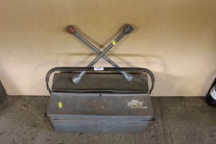 A wheel brace and a metal cantilever tool box with