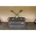 A wheel brace and a metal cantilever tool box with