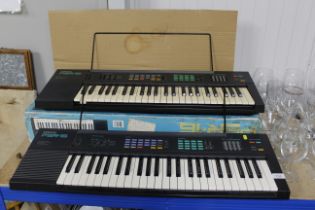 Two Yamaha keyboards, one with box