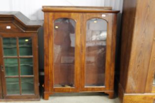 A Victorian mahogany bookcase enclosed by a pair o