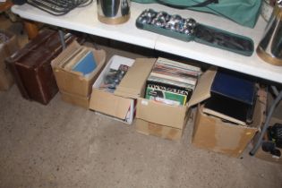 A vintage suitcase and contents and boxes of sheet