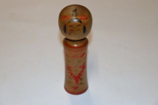 A vintage wooden Kokeshi doll with character mark