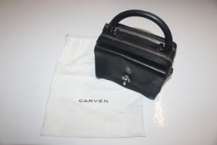 A Carven box handbag; a further patent handbag and