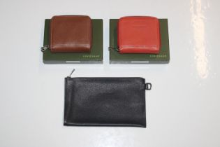 Two Longchamp coin purses, one orange, one brown a