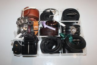 A small Perspex tray of various belts