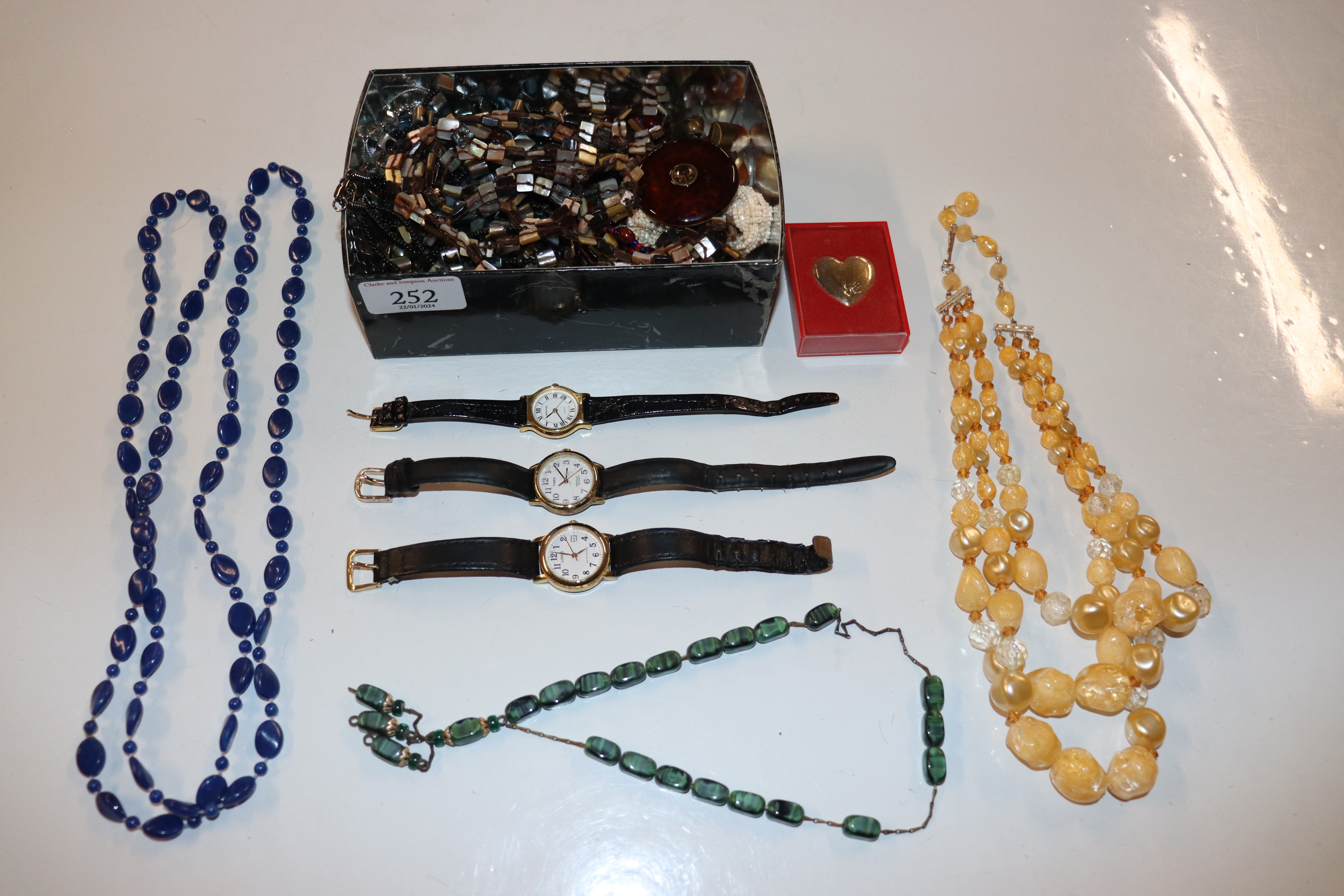 A box of costume jewellery including bead necklace