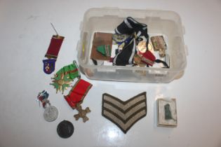 A box containing mixed medals, badges, buttons etc