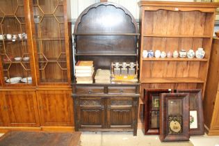 An oak and linen fold decorated dresser fitted two