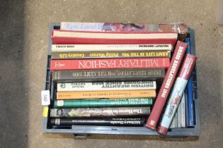 A box of various military uniform books