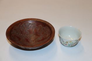 An oriental floral decorated tea bowl having six character marked to base (chip to rim) and a