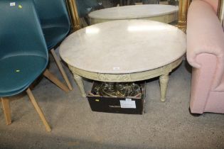 A marble topped oval coffee table