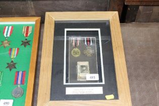 A frame of German WWI medals and match box cover