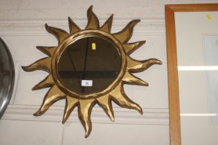 A wall mirror in the form of a blazing sun