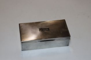A silver cigarette box with engraved initialled F