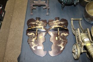 A pair of lacquered folding wall brackets with gil