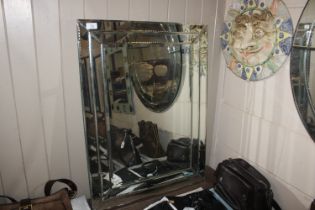 A rectangular cut glass wall mirror