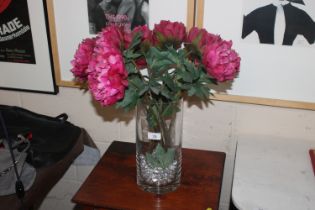 A glass vase of artificial flowers