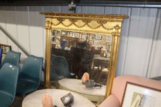 A gilt framed bevelled edge over mantle mirror